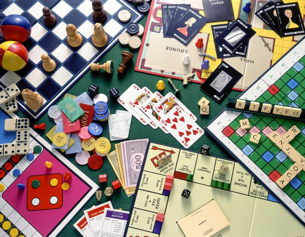 board games (Monopoly, Chess, Cluedo, Scrabble) with playing cards and chips